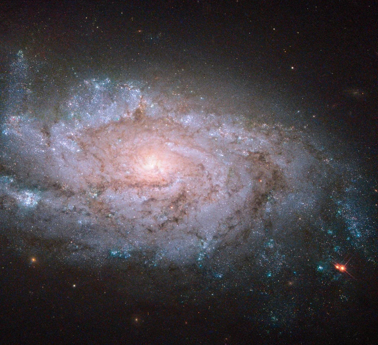 Hubble Sees a Spiral Home to Exploding Stars