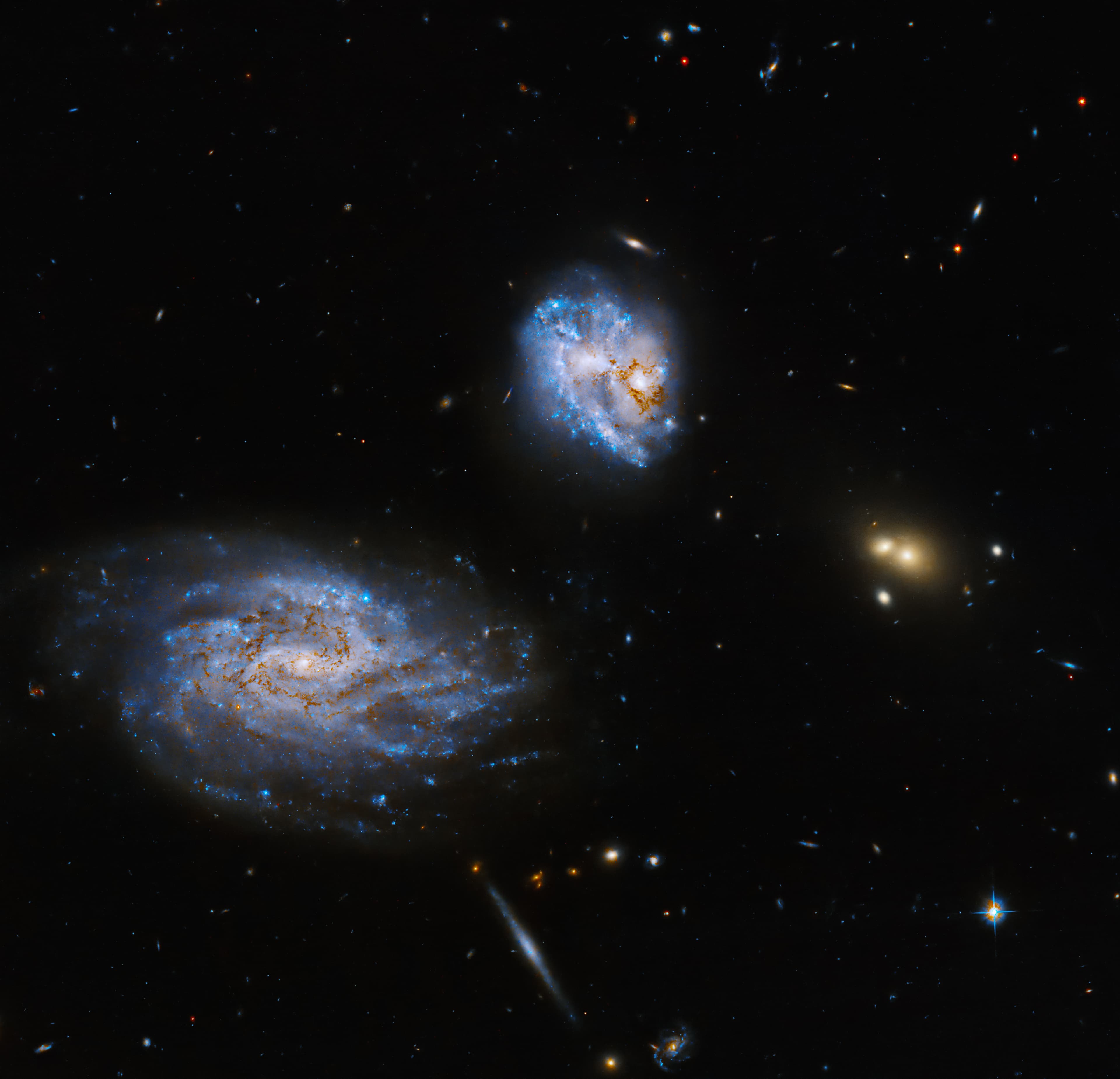 Hubble Observes an Askew Galaxy Coaxing Star Formation from its Partner
