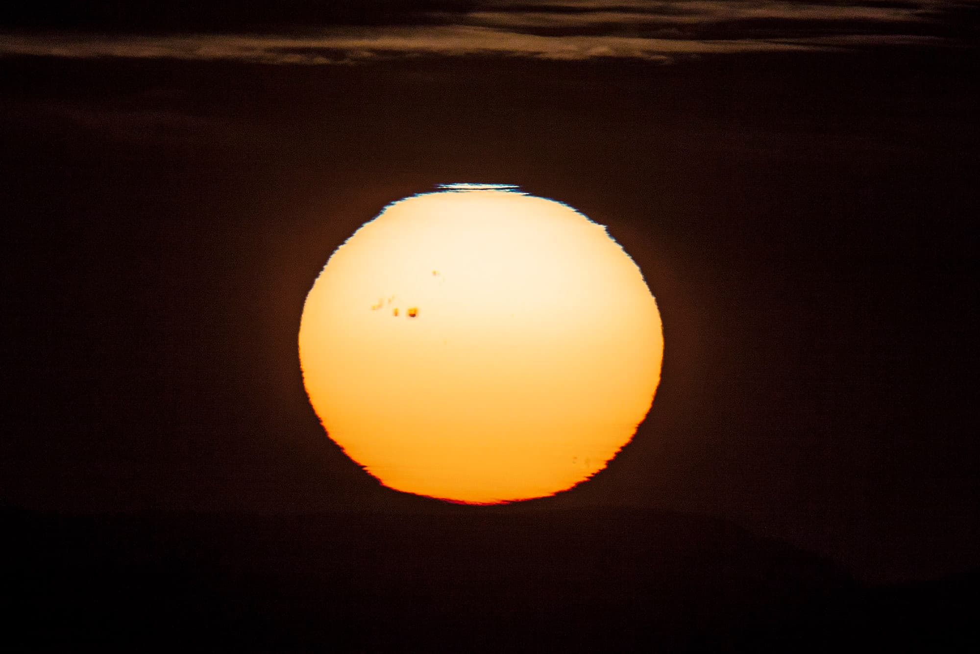 APOD: 2014 January 8 – Sunspot at Sunset