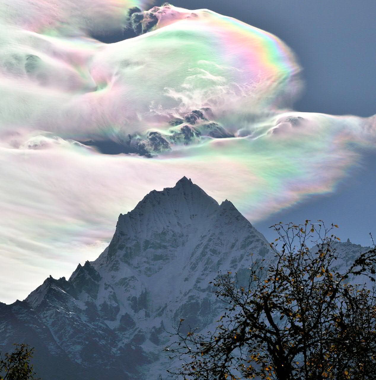 APOD: 2014 July 8 – Iridescent Clouds over Thamserku