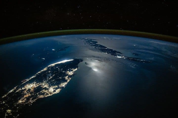 City Lights Glow Along Moonlit Waters